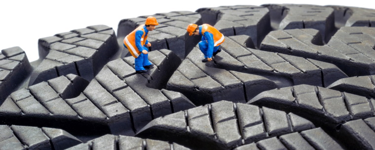 Animated workers on tyre tread