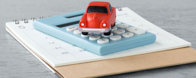 Toy car sitting on a calculator 