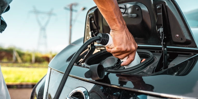 Person charging electric car