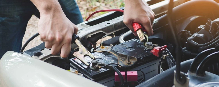 Person jump starting a car