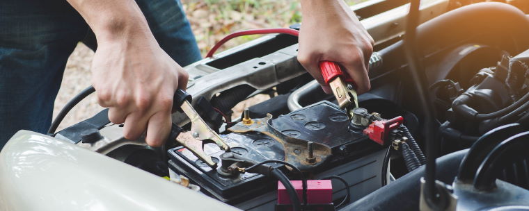 Mechanic Connecting Jump Leads to a Car Battery