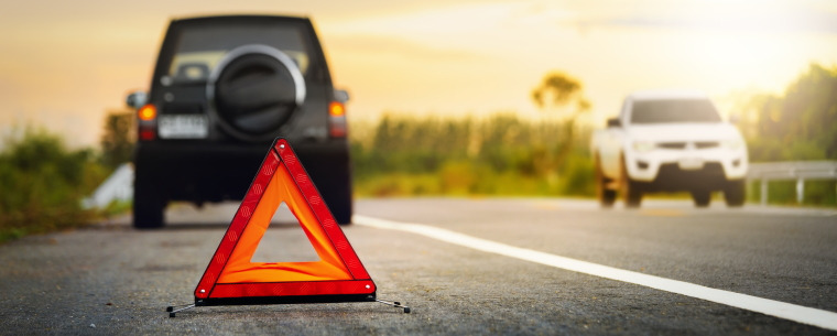 Red warning triangle on the side of a road