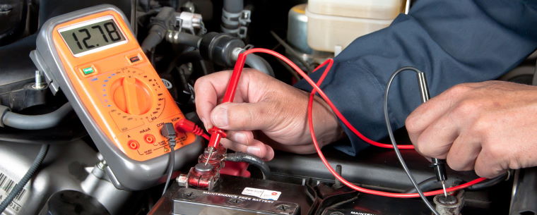 Technician testing a car battery 