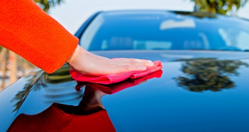 Car being cleaned with sponge 