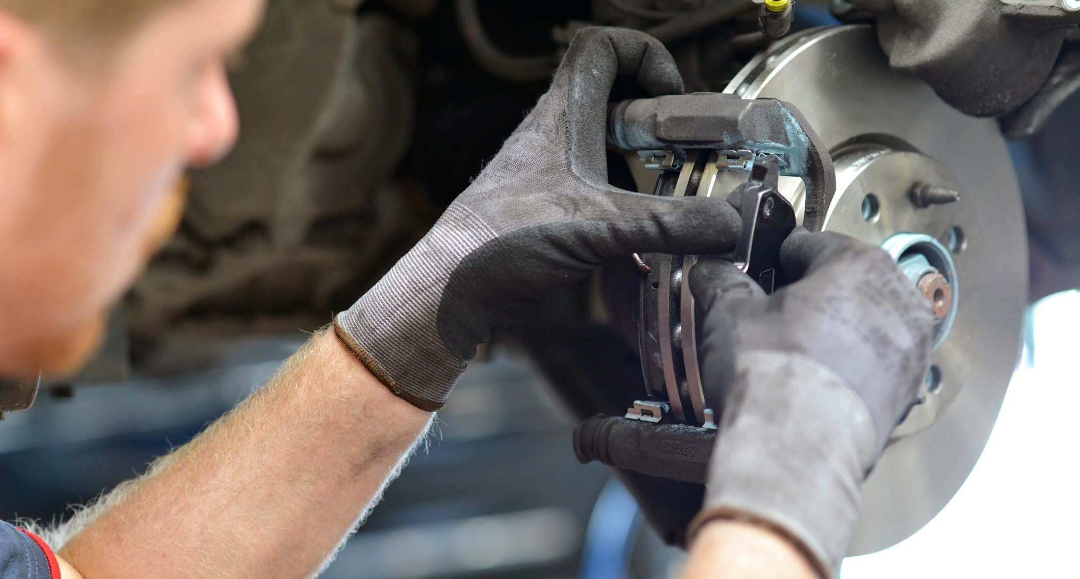 Trained Technician Looking at the Brakes on a Car for Causes of Brake Fade