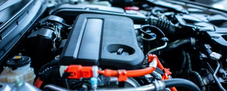 Car engine underneath the bonnet of a vehicle.