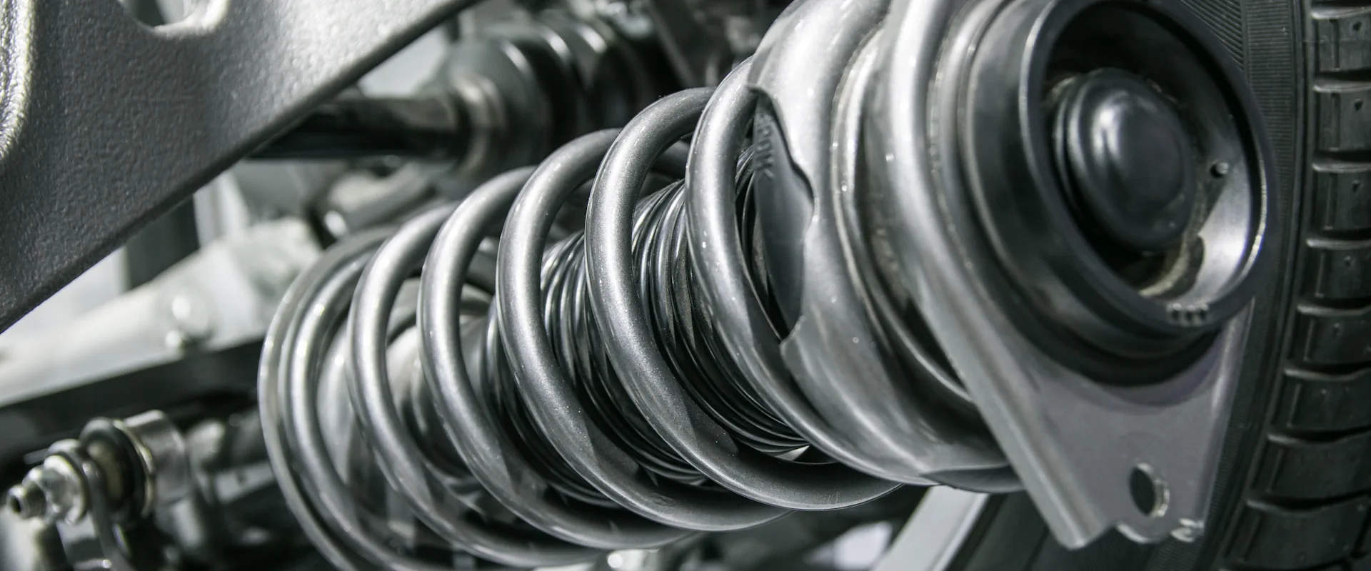 A coiled suspension spring inside a wheel arch