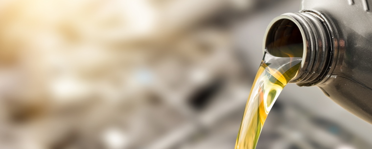 Engine oil being poured from a bottle.