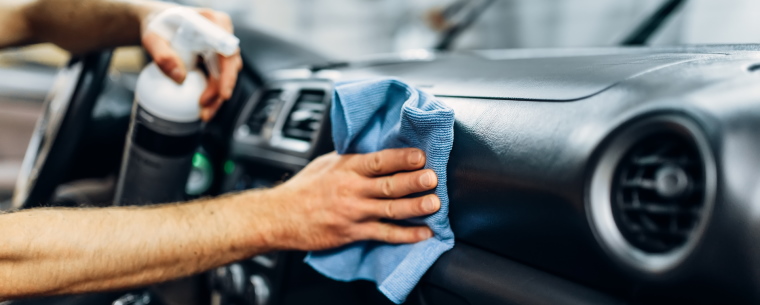 Wiping down a car dashboard